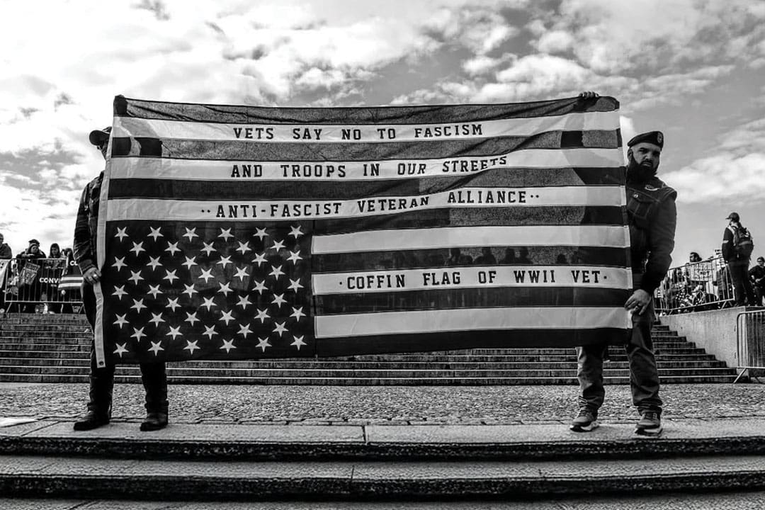 Vets hold anti-fascist flag at March 4 Democracy rally in Washington, D.C.